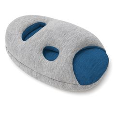 a grey and blue pillow with holes in the middle on a white background, it is made out of felt