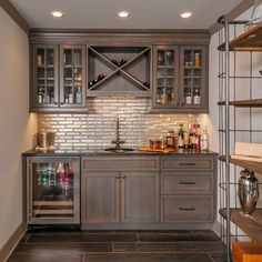 a kitchen with grey cabinets and stainless steel shelvings on the wall above the sink