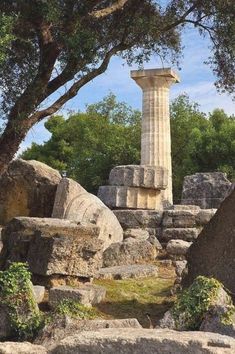 an ancient monument surrounded by rocks and trees