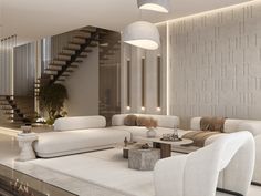 a living room filled with white furniture next to a stair case on the wall and floor