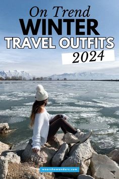 a woman sitting on rocks near the water with text overlay that reads, on trend winter travel outfits 2012