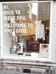 a store window with clothes in it and the words, nice to meet you welcome to anecote