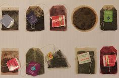 several different types of tea bags and tags on a white surface with labels attached to them