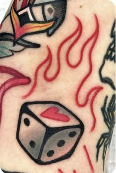 a close up of a person's arm with tattoos on it and dices