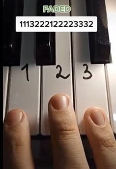 someone has their fingers on the keys of a piano and is pressing them to read it