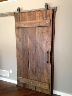 an open wooden door in the corner of a room