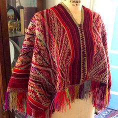 This Is A Beautiful Hand Woven And Super Bright Colors Peruvian Poncho. It Has Fringe All The Way Around. It Is In Very Good Condition. Just One Tiny Snag And A Little Loosening On The Back At The Shoulders. Please See The Last Two Photos. It Is One Size But Measures Shoulder To Shoulder About 16 Inches, And Shoulder To The End Of The Fringe Is About 23 Inches. The Back Hangs Lower Than The Front Of The Poncho. Great Looking Heavy Woven Fabric With Amazing Pinks Reds And Oranges! A Great Additio Traditional Red Poncho For Festivals, Red Bohemian Poncho With Fringe, Traditional Fringe Poncho One Size, Red Bohemian Poncho For Festival, Bohemian Red Shawl Cape, Handwoven Poncho Shawl For Festivals, Multicolor Fringe Shawl Poncho, Handwoven Festival Poncho Shawl, Red Folk Style Poncho For Festival