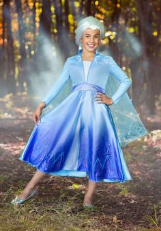 a woman in a blue and white dress posing for the camera