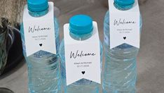 three water bottles with name tags on them