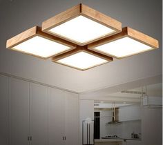 an overhead view of a kitchen with white cabinets and wooden lighting fixtures on the ceiling