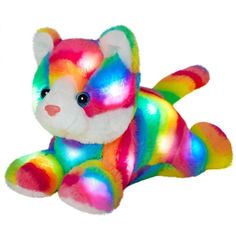 a rainbow colored teddy bear sitting on the ground