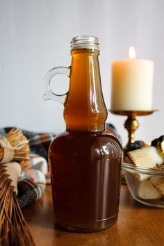 a bottle of beer sitting on top of a table next to a bowl of food