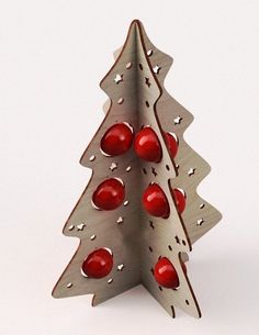 a metal christmas tree with red balls on it