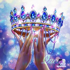 two hands holding up a tiara with blue and pink jewels on it's head