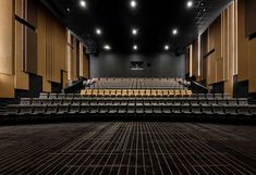 an empty auditorium with rows of seats and no one in the room or on the floor