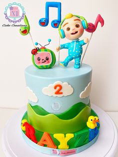 a birthday cake decorated with music and animals