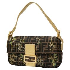 Beautiful vintage FENDI baguette with iconic monogram and embroideries. Delivered in its original Fendi dustbag ! Condition: very good Made in Italy Collection : Baguette Style : woman Material : Zucca canvas, leather inserts Interior: blue satin Color: brown monogram, green and gold embroidery Dimensions: 26.5 x 16 x 4 cm Year: circa 1990-2000 Hardware: golden metal Details: floral embroidery with gold thread, snap closure, gold leather handle, sequined Fendi logo Designer Brown Baguette Bag, Designer Beige Baguette Bag, Designer Brown Bags With Embroidered Logo, Brown Rectangular Bag With Embroidered Logo, Formal Gold Baguette Bag, Fendi Vintage Baguette, Vintage Fendi Baguette, Fendi Zucca Baguette, Fendi Monogram