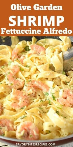 a pan filled with shrimp and pasta on top of a table