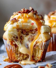 a muffin with pecans and caramel drizzled on the top