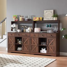 a room with a rug, table and shelves on the wall that have items on top of them