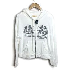 Hollister Embroidered Zip Up Hoodie Sweatshirt Jacket Brand New With Tags! Size: M 56% Cotton, 41% Polyester, 3% Viscose Gray Embroidered Tropical Scene & Logo. 2 Front Waist Pockets. Drawstring Hoodie. Super Soft Fleece Inside. Machine Wash. Chest:(Under Arm To Under Arm) 21.5” Flat Across Waist: 21” Flat Across Sleeve Length: 25” Jacket Length:(Top Shoulder To Hem) 21.5” 1022 White Casual Hoodie Top, Casual White Hoodie Top, White Relaxed Fit Casual Hoodie, Reworked Hoodie, Hollister Sweatshirt, Hollister Logo, White Pullover Sweater, Grey Cropped Hoodie, Hollister Hoodie