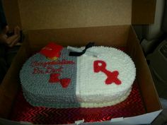 a cake in the shape of a heart with red and grey frosting