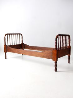 an old wooden bed frame with slatted headboard and foot board on white background