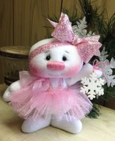 a stuffed animal wearing a pink tutu with snowflakes