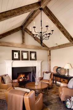 a living room with couches, chairs and a fire place in the fireplace area