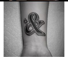 a black and white photo of a tattoo on the wrist with an amposcope