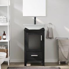 a white sink sitting next to a toilet in a bathroom under a mirror and shelf