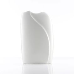 Here we offer a stylish, minimalist vase for sale. The vase is made of white porcelain and has a smooth, glossy surface. Its design is simple and elegant, with gentle curves and an organic shape reminiscent of a flower bud or an abstracted natural form. The vase has an asymmetrical opening at the top and its reduced aesthetic makes it look very modern and timeless.  This design piece is ideal as a decorative element in modern interiors and can be used both on its own and with flower arrangements. The simplicity and elegance of the shape make the vase a versatile and stylish accessory that fits well into different interior styles.  Excellent condition! Very minor signs of wear, no breaks, cracks or rough scratches. See pictures. The item is cleaned, fully functional and ready to use!  - Pro Minimalist Vase, Arabia Finland, Green Glass Vase, Vases For Sale, Explainer Video, Natural Form, Baker Furniture, Modern Interiors, Interior Styles