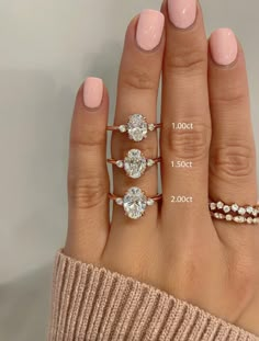 a woman's hand with three different rings on it and the measurements for each ring