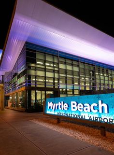 the entrance to my little beach international airport is lit up with blue lights at night