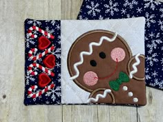 two pieces of fabric are laying on the floor next to each other, one with a gingerbread cookie on it