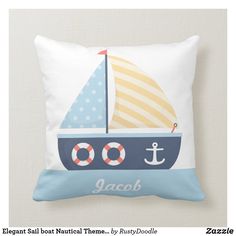 a blue and white pillow with a sail boat on it