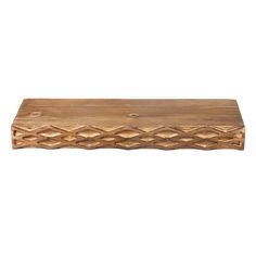 a wooden shelf that is made out of wood and has an intricate design on the top