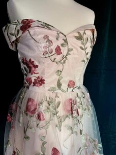 a white dress with pink flowers on it