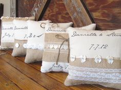 three burlap and lace pillows with wedding date written on the back, tied in twine