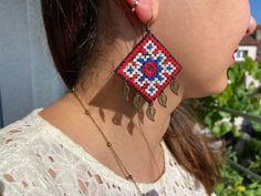 a close up of a person wearing some kind of earring with beads on it