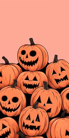 a pile of jack o lantern pumpkins with faces drawn on them in front of a pink background