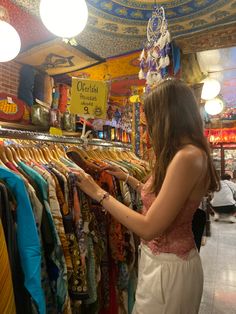 a woman looking at clothing in a store