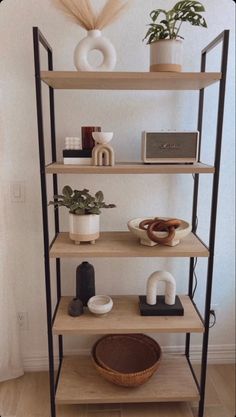 a shelf with some plants and other items on it