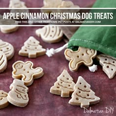 some cut out cookies sitting on a table next to a green bag and drawstring