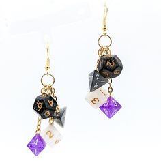 Asexual pride flag colors in an awesome pair of miniature dice earrings! If you've been eyeing our full-size dice earrings but haven't bought them because of the weight or they're just too big for you... we've got you covered! These sweet earrings are made of actual half-size (about 10mm) polyhedral dice in the colors of the asexual pride flag, making them perfect for lovers of DND, Pathfinder, or other RPGs.Each earring has 4 mini dice (black, gray, white, purple) hanging from individual chains Bigender Earrings, Non Binary Earrings, Dnd Earrings, Dnd Jewelry, Dice Accessories, Dice Jewelry, Asexual Flag, Dice Earrings, Geeky Jewellery