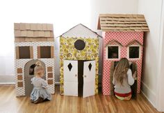 three children are playing in their play houses