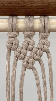 a close up view of the end of a wooden chair with ropes attached to it