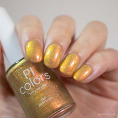 The image features a close-up of a hand with short nails adorned with a shimmery, golden-yellow nail polish. In the hand, an elegantly held bottle displays the label PI Colors. This luxurious nail polish, named Golden Fuyuki.000, boasts a glossy and iridescent finish complemented by metallic gold holo glitter for an added touch of allure. Silver Nail Polish, Grey Nail Polish, Brown Nail Polish, Orange Nail Polish, Gold Nail Polish, Gold Nail Designs, Purple Nail Polish, Green Nail Polish, Gold Nail