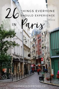 an alley way with people walking on it and the words, 20 things everyone should experience in paris