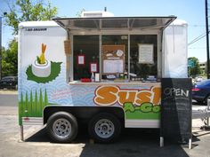 the food truck is parked on the side of the road